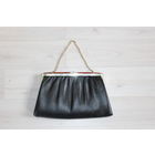 Женская сумочка с металлической цепочкой и застежкой.