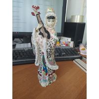 Статуэтка японка в зимнем одеянии со странным инструментом.